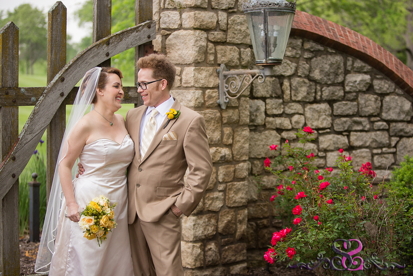 18 - bride and groom smile in classic brick and wood entrance lawrence wedding photographer