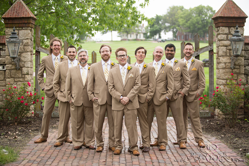 20 - groomsmen smilling in front of wooden gate grand rapids michigan wedding photographer