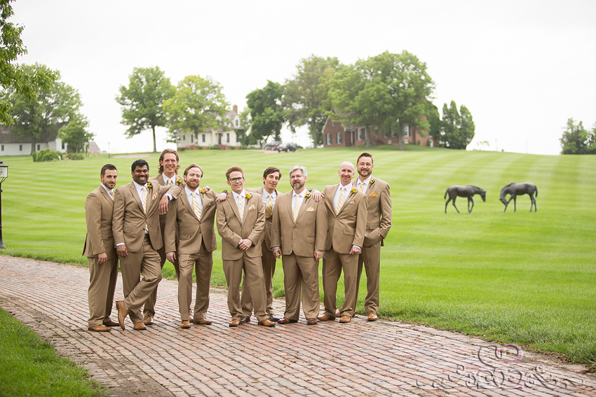 21 - groomsmen smile on brick pathway with horse statues lawrence wedding photographer