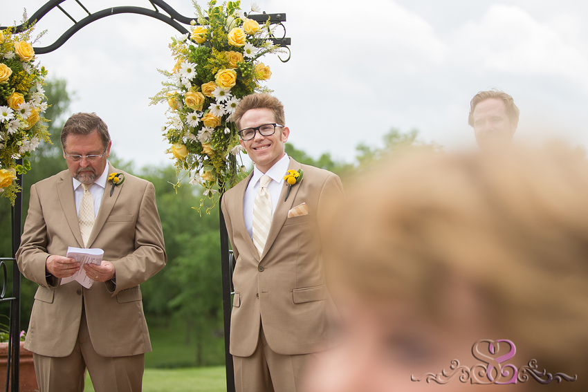 27 - groom smiles seeing bride walk down aisle grand rapids michigan wedding photographer