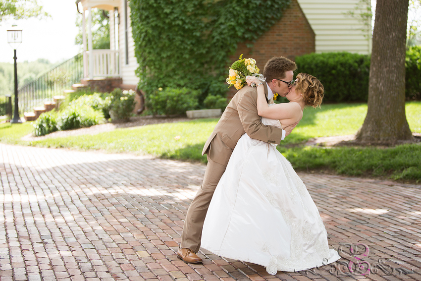 56 - bride and groom share kiss on brick pathway lawrence wedding photographer