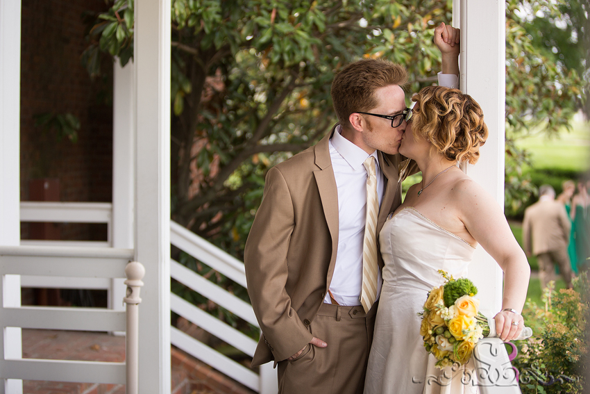 58 - bride and groom share kiss on porch grand rapids michigan wedding photographer