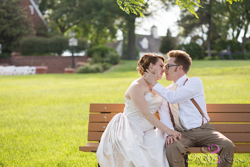 69 - bride and groom share kiss on bench mildale farms edgerton kansas