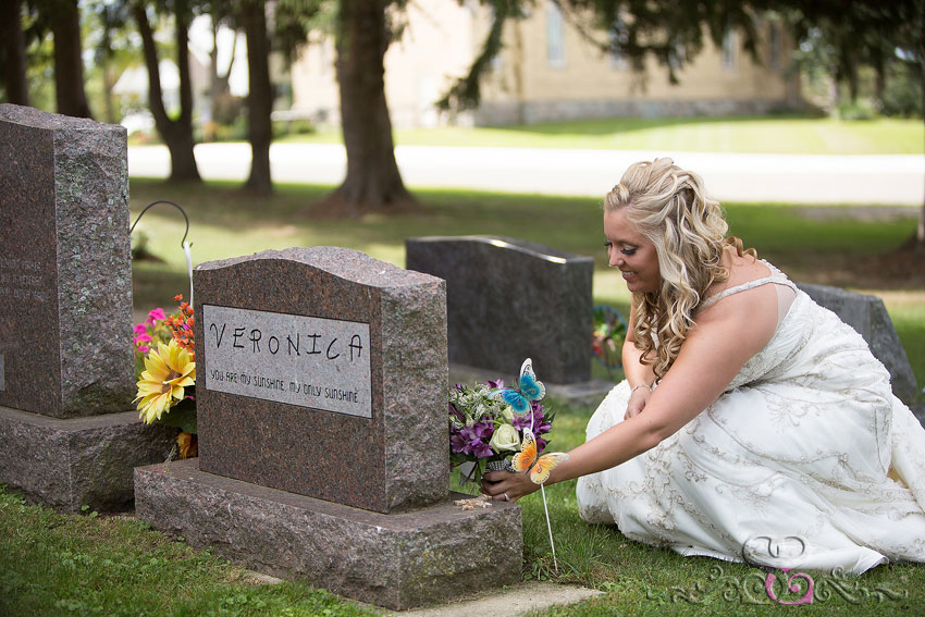 06-bride-places-bouquet-next-to-grave-michigan-wedding-photographer