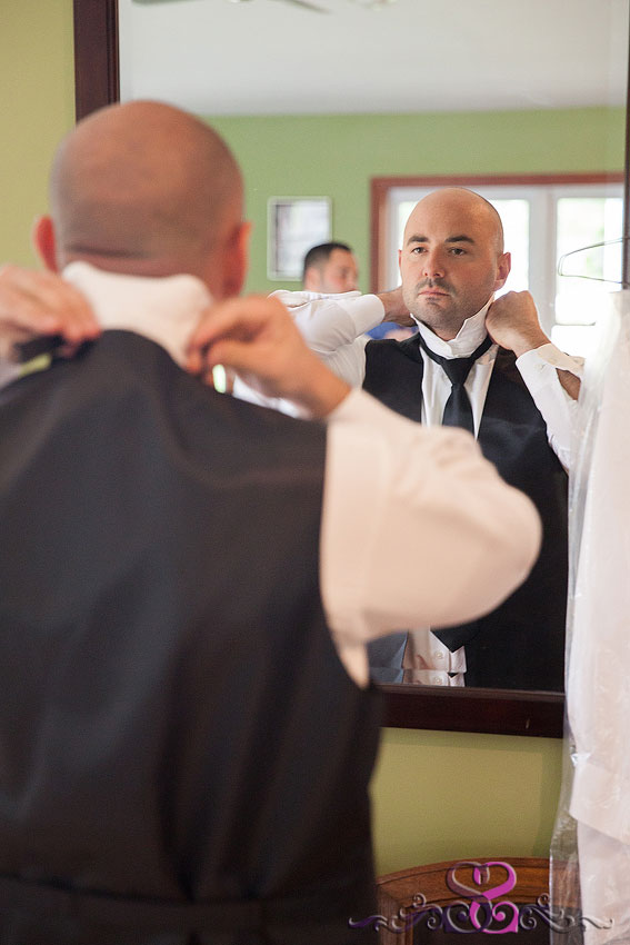 07-groom-fixed-tie-in-mirror-kansas-city-wedding-photographer