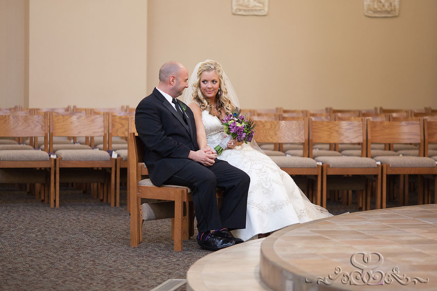 18-bride-and-groom-exchange-looks-during-ceremony-michigan-photographer