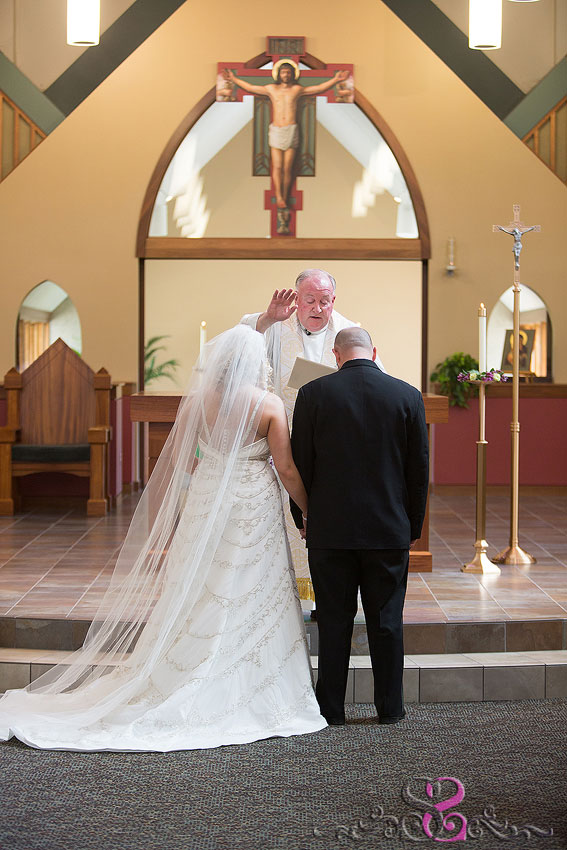 22-bride-and-groom-receive-blessing-from-priest-lawrence-wedding-photographer