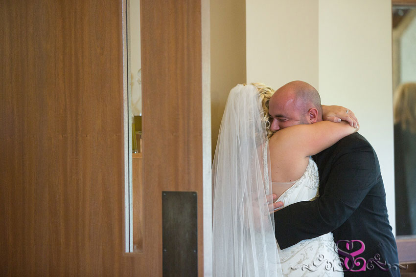 24-bride-and-groom-hug-after-ceremony-michigan-photographer