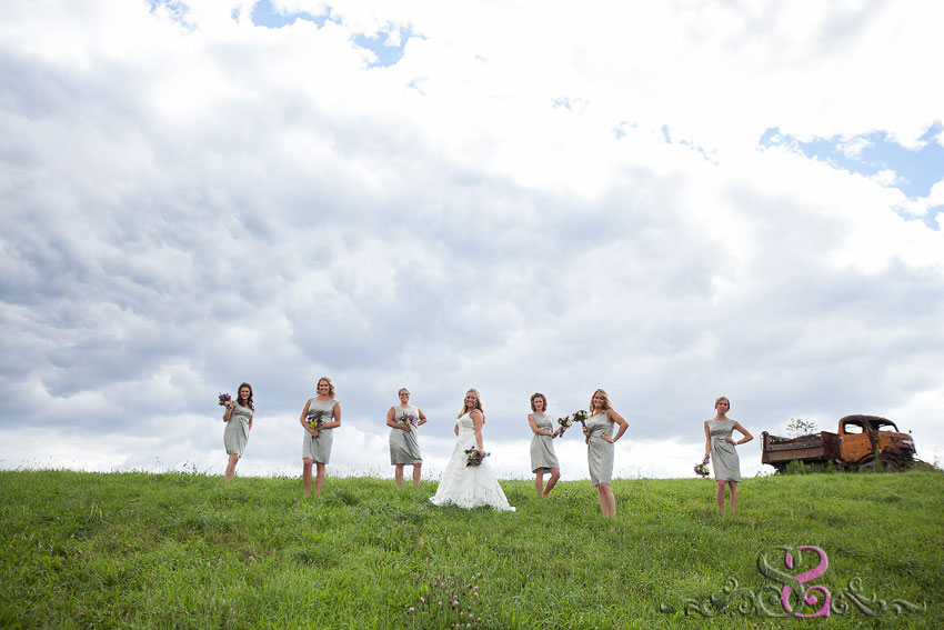 28-bridesmaids-on-grassy-hill-with-old-truck-michigan-wedding-photographer