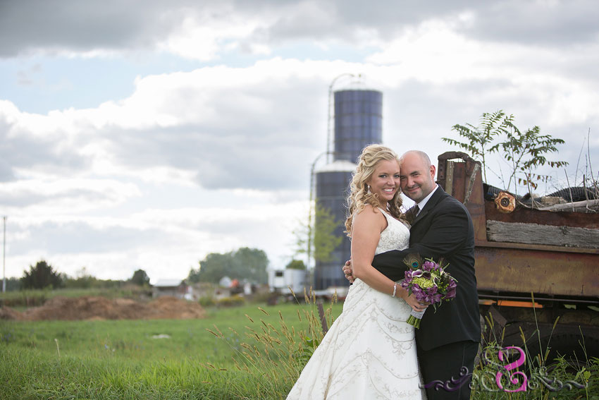 30-bride-and-groom-smile-with-farm-in-background-lawrence-wedding-photographer
