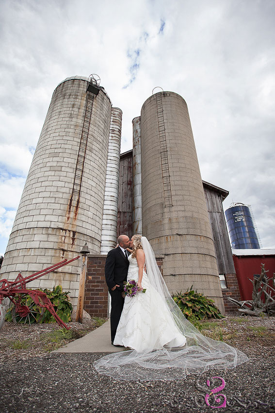 32-bride-and-groom-kiss-in-front-of-large-silos-lawrence-wedding-photographer