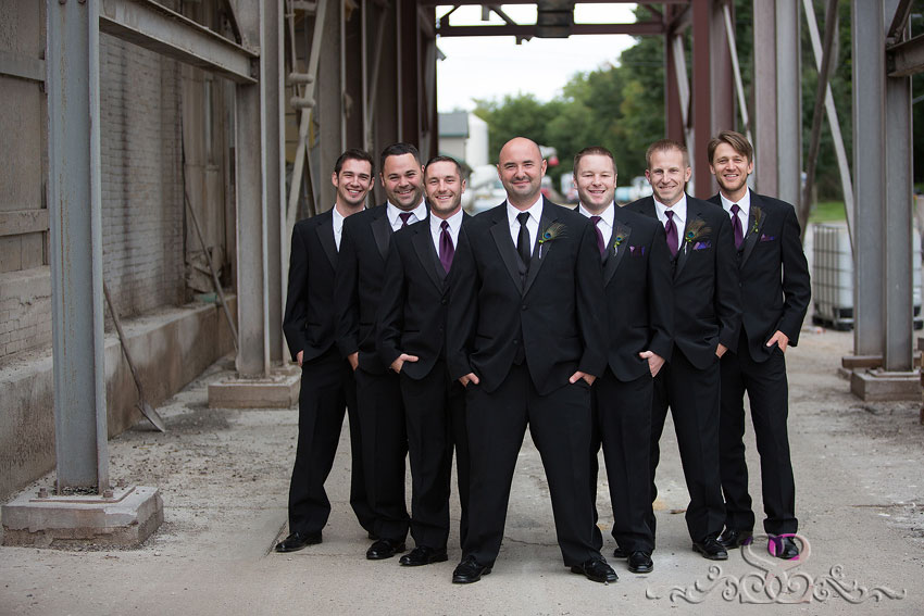35-groomsmen-pose-under-architecture-kansas-photographer
