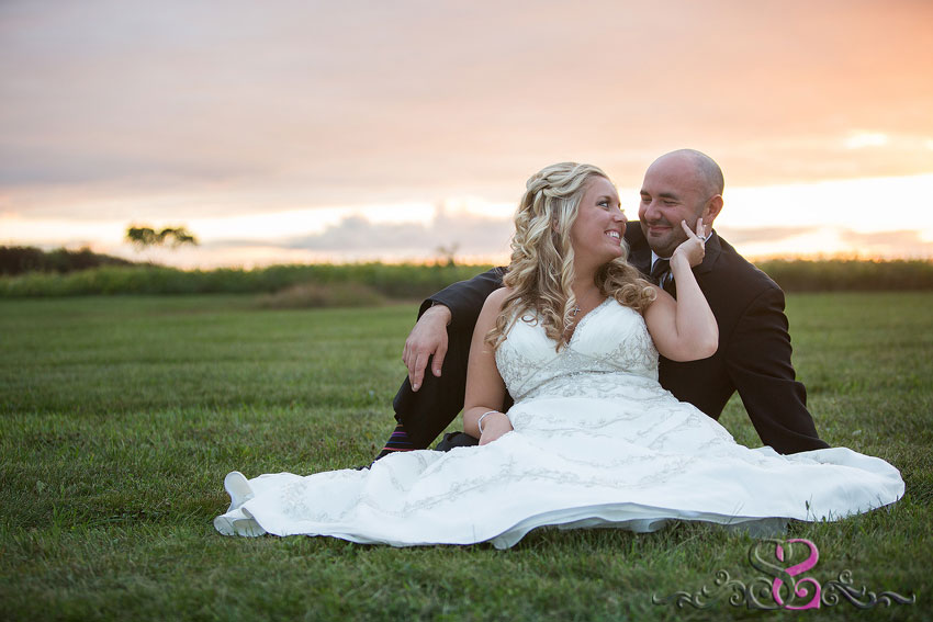 41-bride-and-groom-sit-in-grass-with-sunset-lawrence-wedding-photographer