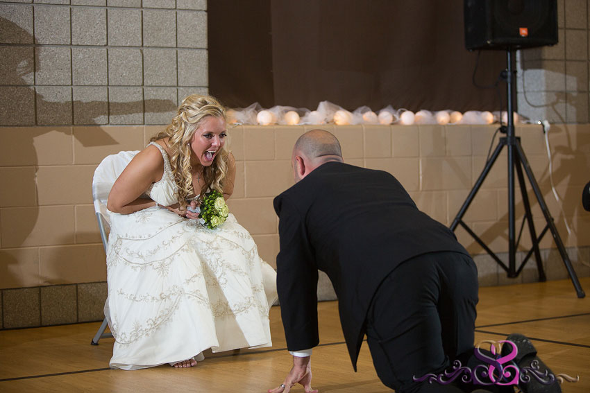 47-groom-crawls-towards-bride-for-garter-toss-kansas-city-wedding-photographer