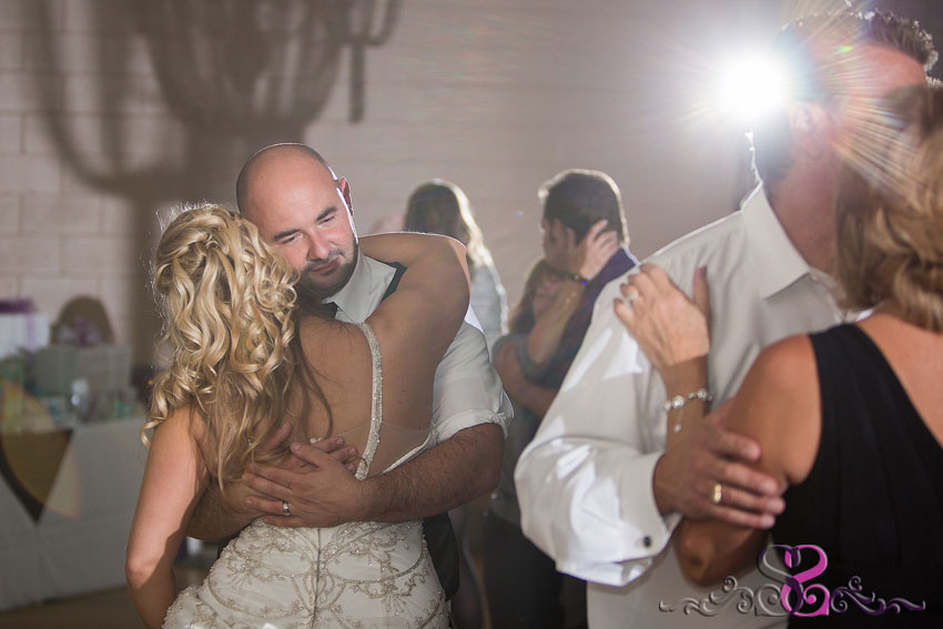 51-bride-and-groom-embrace-during-reception-michigan-photographer