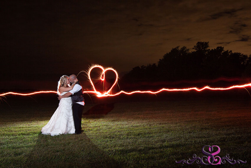 54-bride-and-groom-kiss-with-sparkler-heart-lawrence-wedding-photographer