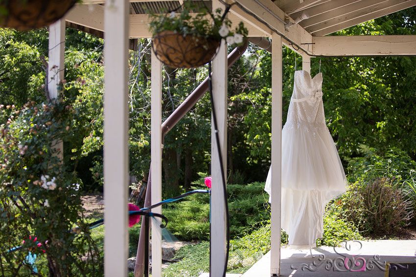 03-brides-dress-hangs-from-porch-kansas-wedding-photographer