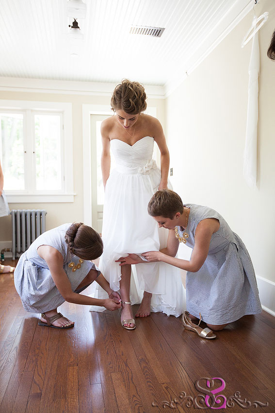 10-bridesmaids putting gold heels on bride michigan wedding photographer