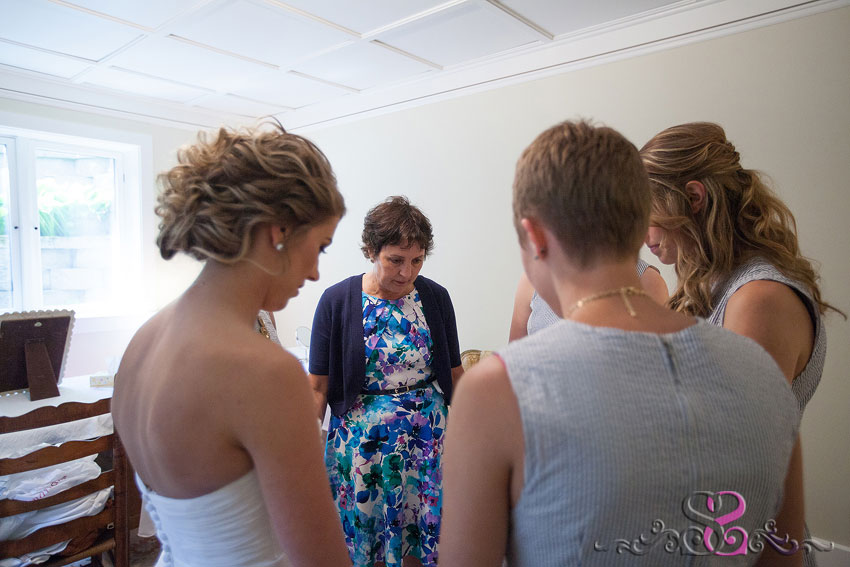 24-bridesmaids pray for bride michigan wedding photographer