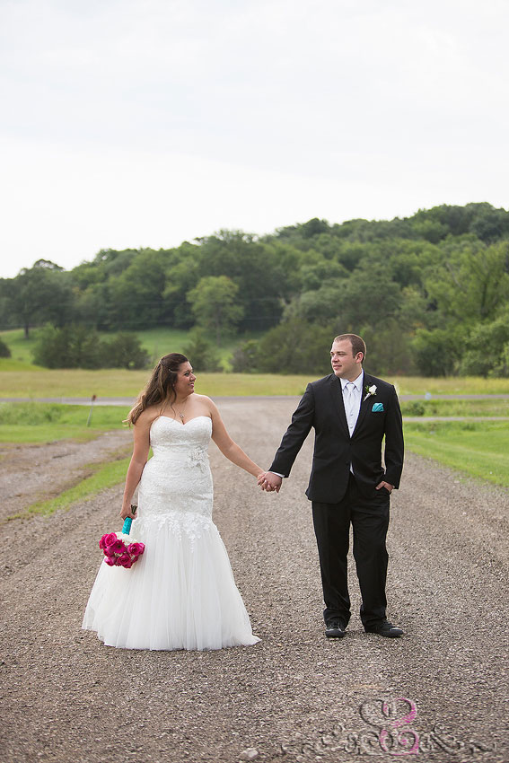 29-bride-and-groom-smile-at-each-other-on-dirt-road-lawrence-photographer