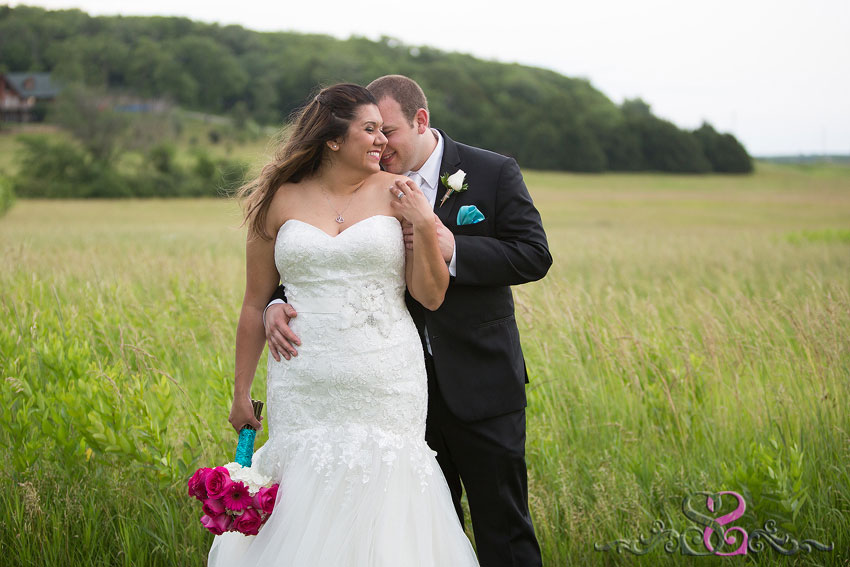 32-bride-and-groom-snuggle-in-field-michigan-wedding-photographer