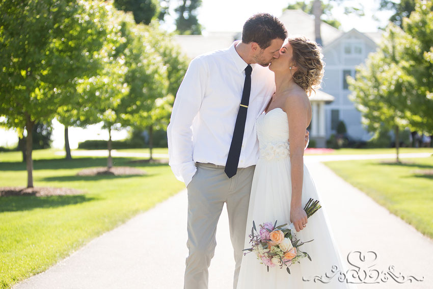 42-bride and groom backlit kiss in driveway michigan wedding photographer
