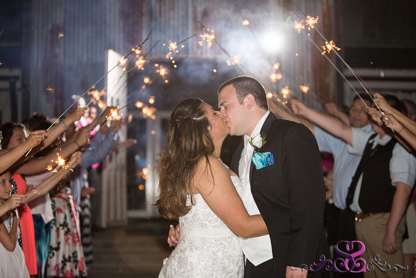 49-bride-and-groom-kiss-in-sparkler-tunnel-kansas-city-wedding-photographer