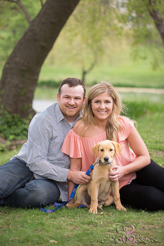 06-engaged couple sit in grass with puppy lawrence wedding photographer