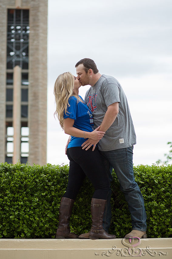 21-engaged couple kiss in front of campanile grand rapids wedding photographer kansas university campus engagement session