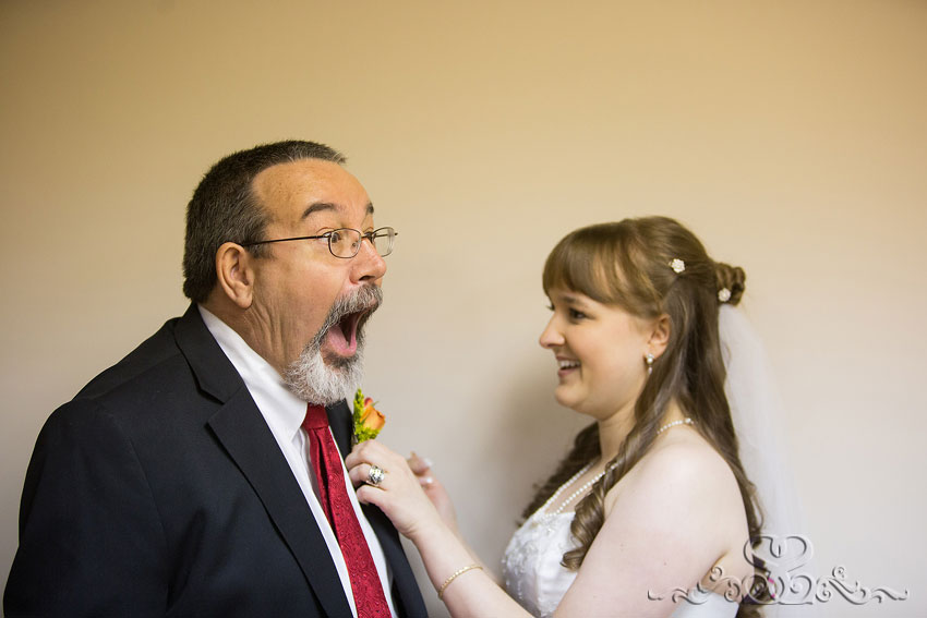 15-father-jokes-with-bride-pinning-on-boutenierre-grand-rapids-wedding-photographer
