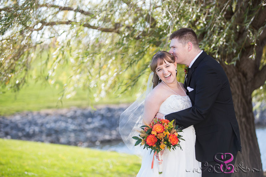 34-bride-laughing-with-groom-hugging-her-michigan-photographer-Fall-Wedding-at-Waterford-Crossing-Goshen-IN