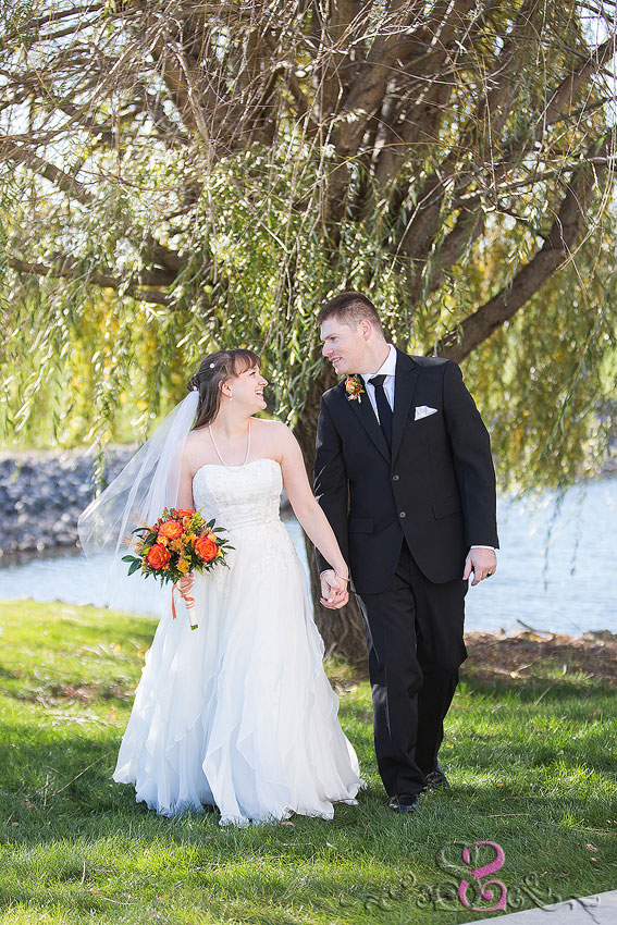 35-bride-and-groom-smile-and-hold-hands-michigan-photographer