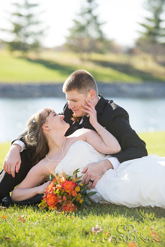 40-bride-and-groom-lay-in-grass-michigan-photographer