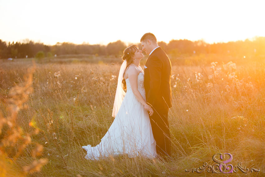 58-bride-and-groom-stand-in-field-awashed-in-sunlight-indiana-wedding-photographer